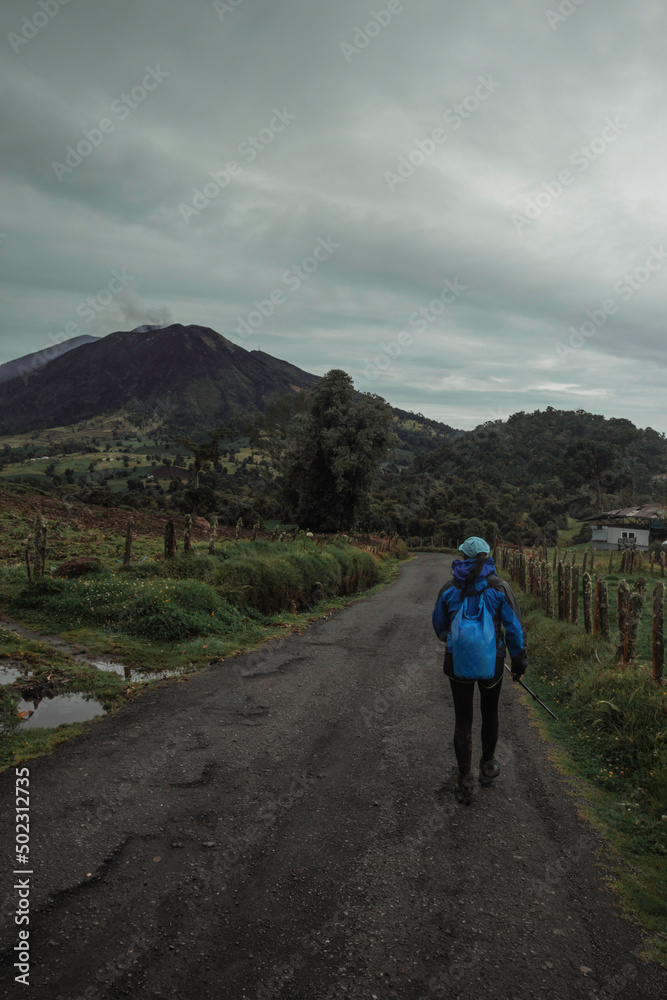 female hiker walking in Turrialba Volcano National Park in Costa Rica