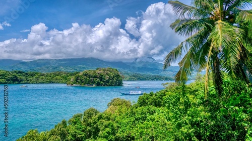 Wide angle view of Dalaruan Bay and the beautiful mountains and coastline of the popular seaside resort of Puerto Galera on Mindoro Island, Philippines. photo