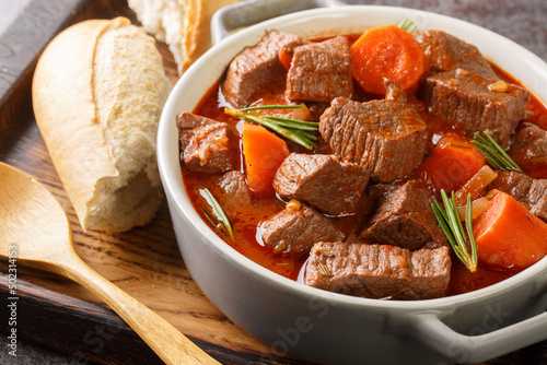 French beef stew in red wine known as daube de boeuf Provencal closeup in the wooden tray on the table. Horizontal