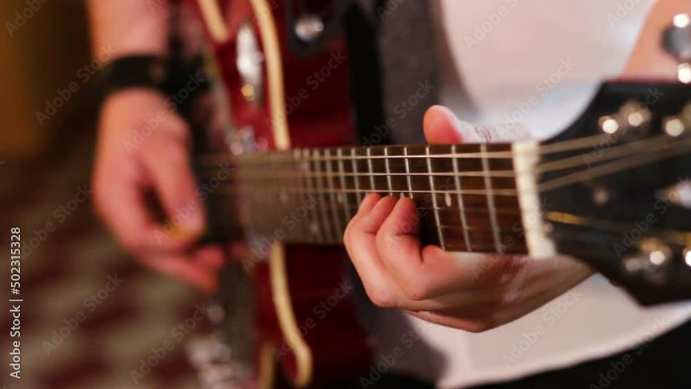 Close up hands playing the electric guitar. Taking chords and notes, beats, making melodies. Close up hands playing the electric guitar. Taking chords and notes, beats, making melodies.