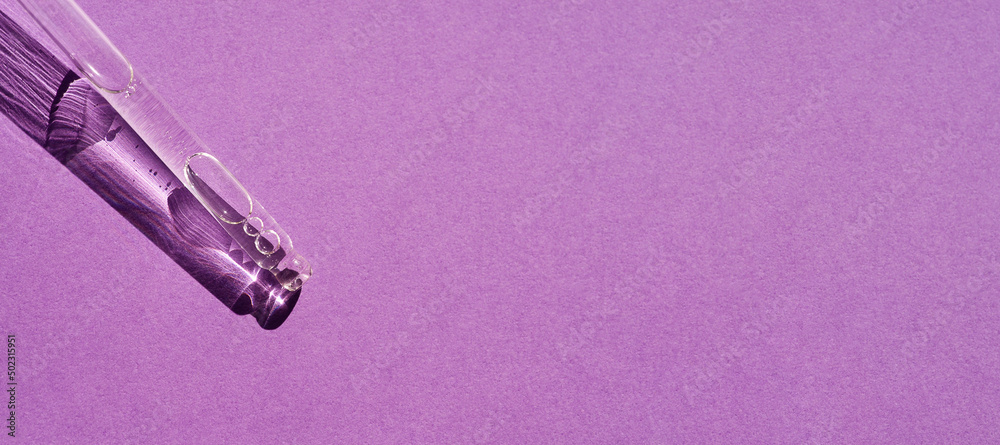 Pipette with serum or cosmetic liquid close-up on a purple background in soft focus. Beautiful shadow in the sunlight. Skincare products , natural cosmetic. Beauty concept for face and body care Pipette with serum or cosmetic liquid close-up on a purple background in soft focus. Beautiful shadow in the sunlight. Skincare products , natural cosmetic. Beauty concept for face and body care
