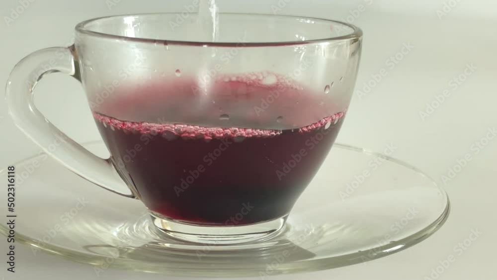Top view shot of making hibiscus tea with hibiscus syrup and hot water Top view shot of making hibiscus tea with hibiscus syrup and hot water
