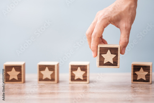 Man hand holding Star block. Customer choose rating for user reviews. Service rating, ranking, customer review, satisfaction, evaluation and feedback concept