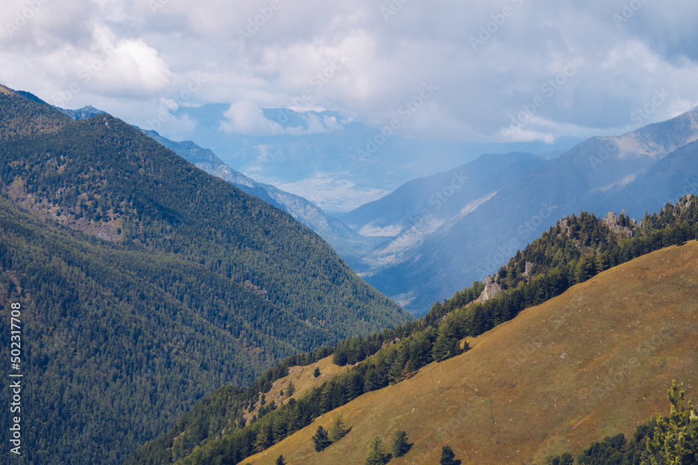 Picturesque marvelous view in the mountains. Amazing mountain range valley scenic landscape among clouds and colordul hills. Autumn season in the mountains stock photography