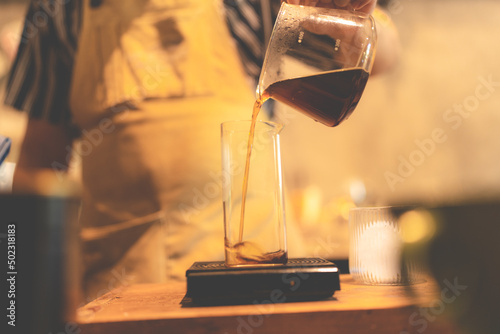 vintage slow bar cafe with drip coffee filter style concept, barista making a hot drink, beverage process brewing hot water and arabica coffee beans powder to a cup, having aroma smell and caffeine
