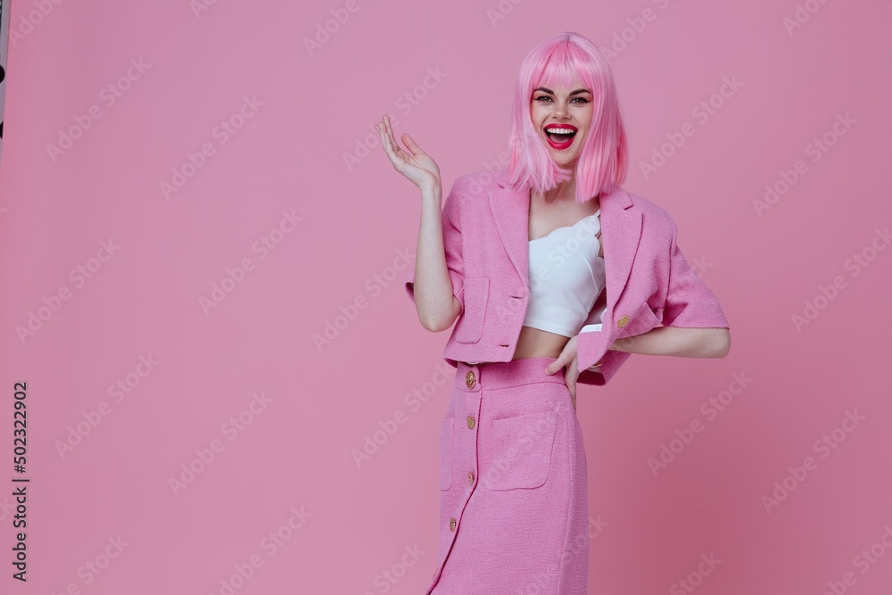 Pretty young female gestures with his hands with a pink jacket color background unaltered Pretty young female gestures with his hands with a pink jacket color background unaltered