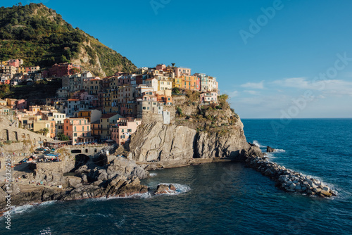 Beautiful view of rocky hills and colorful historic buildings of Manarola, tourist attraction and famous place in Liguria, Italy.