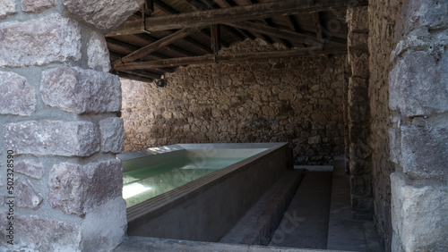 ancient marble wash-house. typical of Sardinian custom. completely refurbished with the fountain and the tap running. photo