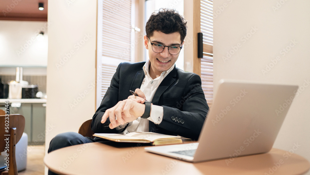 Financier in glasses work office uses a laptop writes a response to the client. Company Report Financier in glasses work office uses a laptop writes a response to the client. Company Report