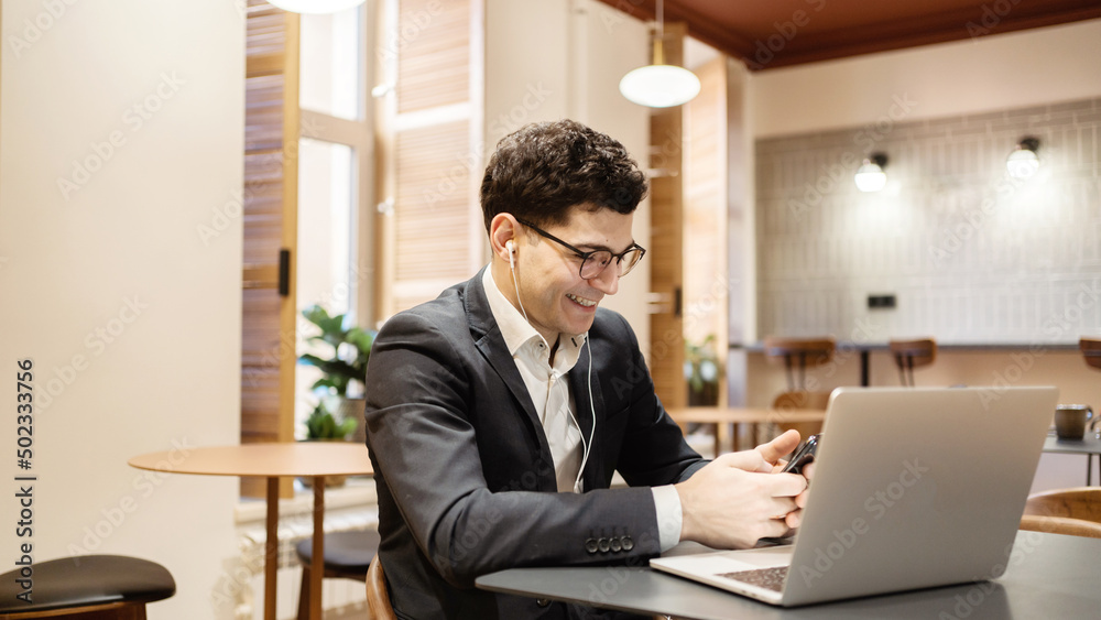 A manager with glasses working office uses a laptop to write a response to the client. Company report video call A manager with glasses working office uses a laptop to write a response to the client. Company report video call