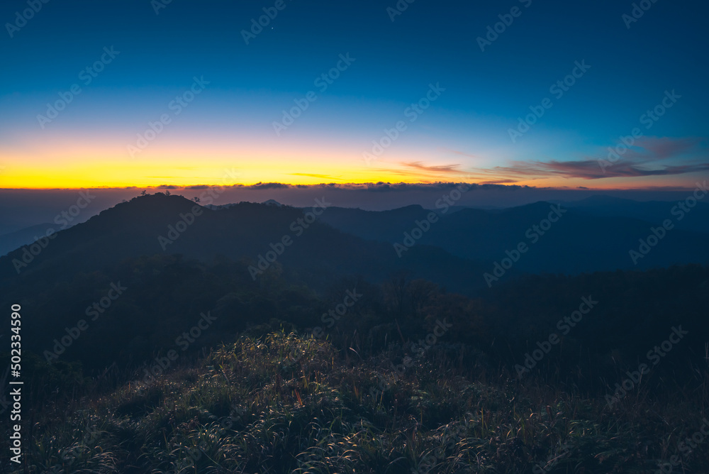 Panorama of Beautiful scenery landscape sunlight in the morning sunrise above flowing fog waves on mountain peak tropical rainforest. rainforest in the morning with fog and sunrise. jurassic forest.