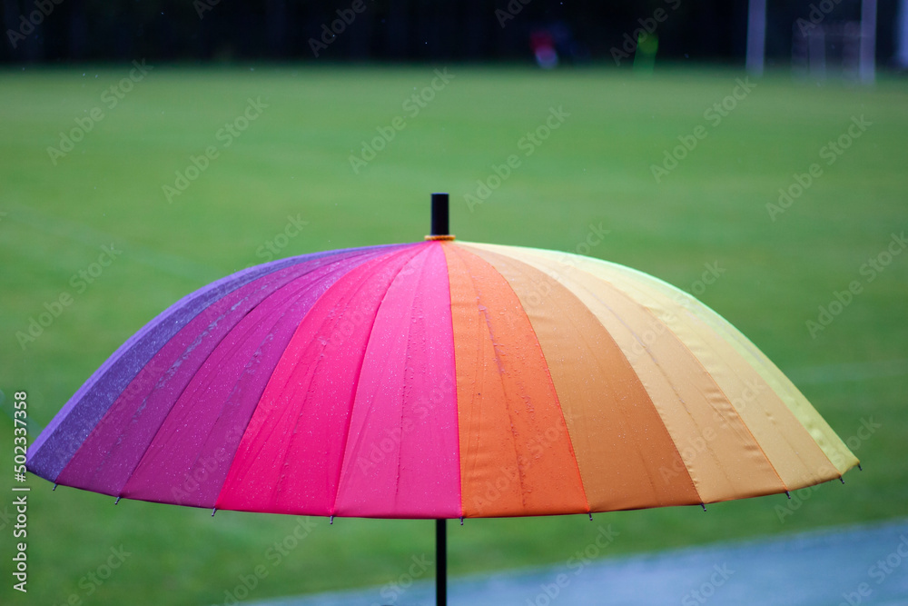 Colored umbrella. Umbrella in rainy weather. Protection against precipitation. Combination of colors from yellow to purple.