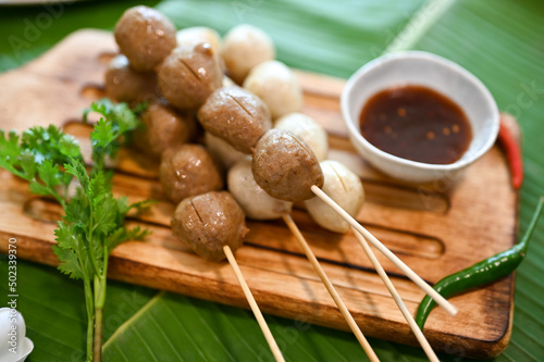 Fototapeta Naklejka Na Ścianę i Meble -  Grilled meat balls on skewer with traditional Thai special sauce