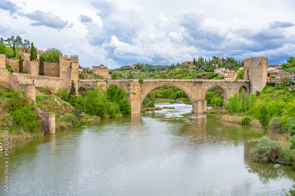 Scenic view of medieval pedestrian San Martin's bridge offering sweeping views of the Tagus River in Toledo, Spain