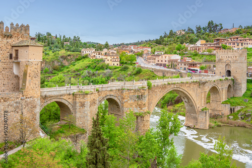 Panoramic view of medieval pedestrian San Martin's bridge offering sweeping views of the Tagus River in Toledo, Spain