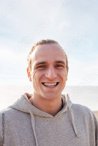 young man smiling happy and looking at camera