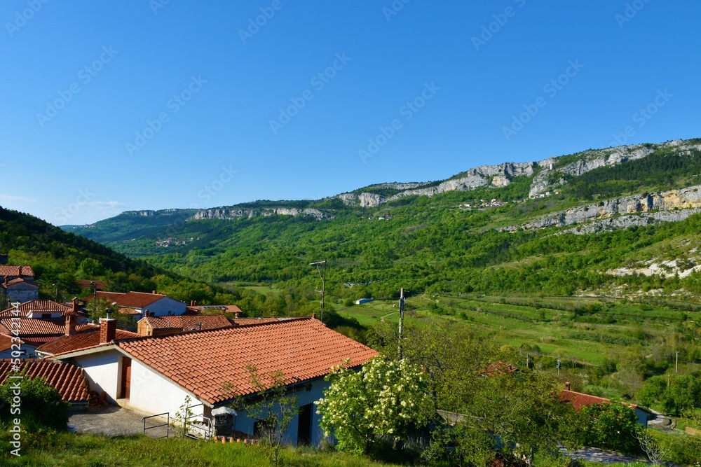 View of Hrastovlje village and rock wall at Karst edge in Primorska and Istria, Slovenia