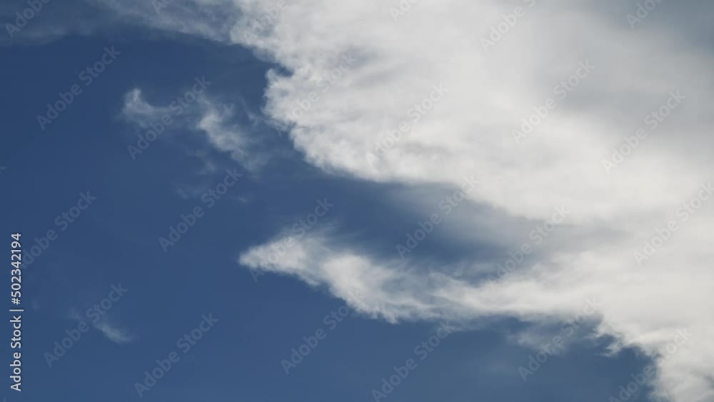 Sky cloud cotton blue clouds beautiful background outdoor moving cloud cluster swirling upward time-lapse . Cloud moving and transforming fast in the clear blue sky . Time lapse cloud beautiful sky Sky cloud cotton blue clouds beautiful background outdoor moving cloud cluster swirling upward time-lapse . Cloud moving and transforming fast in the clear blue sky . Time lapse cloud beautiful sky