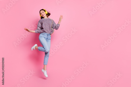 Photo of dreamy sweet woman wear pullover headphones dancing empty space isolated pink color background