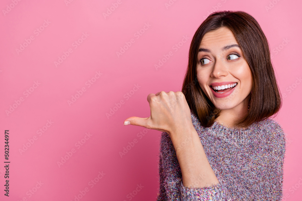 Portrait of attractive cheerful girl demonstrating copy space ad advert like follow isolated over pink pastel color background