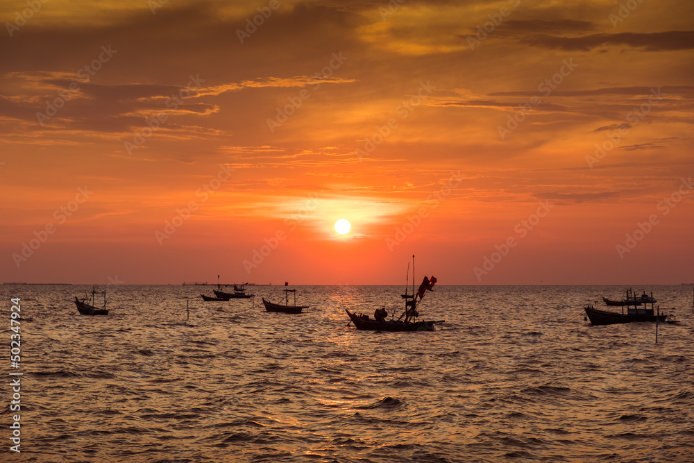 Silhouette of sunset time with fishing Long tail boats (Traditional boats) on the sea sunset silhouette background orange sky 
 
 
