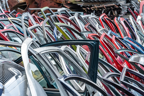 different colored car doors at a car junkyard