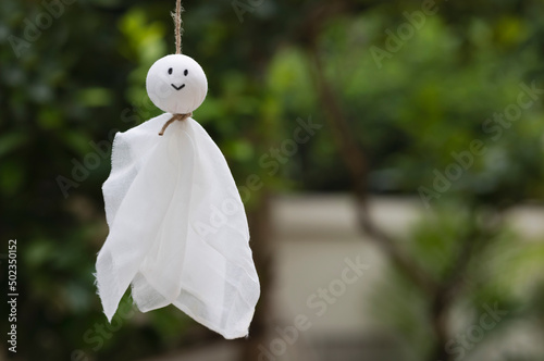 Smile Teru Teru Bozu on green nature background , Japanese rain doll photo