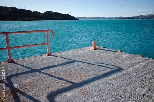 Bitt on pier at Lake Lago General Carrera, Puerto Ibanez, Aysen Province, Patagonia, Chile. Corner of pier for mooring boats on navigable glacial lake with clear bright blue water in Chilean Patagonia photo