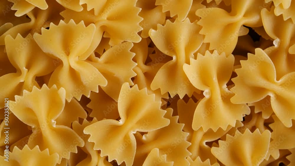 Close up of raw italian bow shaped pasta on rotating table. 4k footage Close up of raw italian bow shaped pasta on rotating table. 4k footage