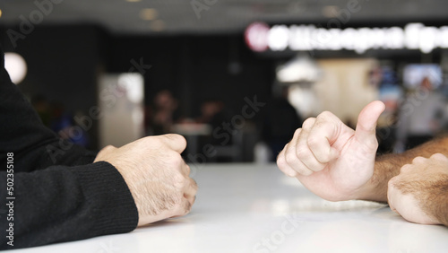 Close up of male hands during effective negotiations. Media. Hands of two men moving during talking, concept of business and making agreement.