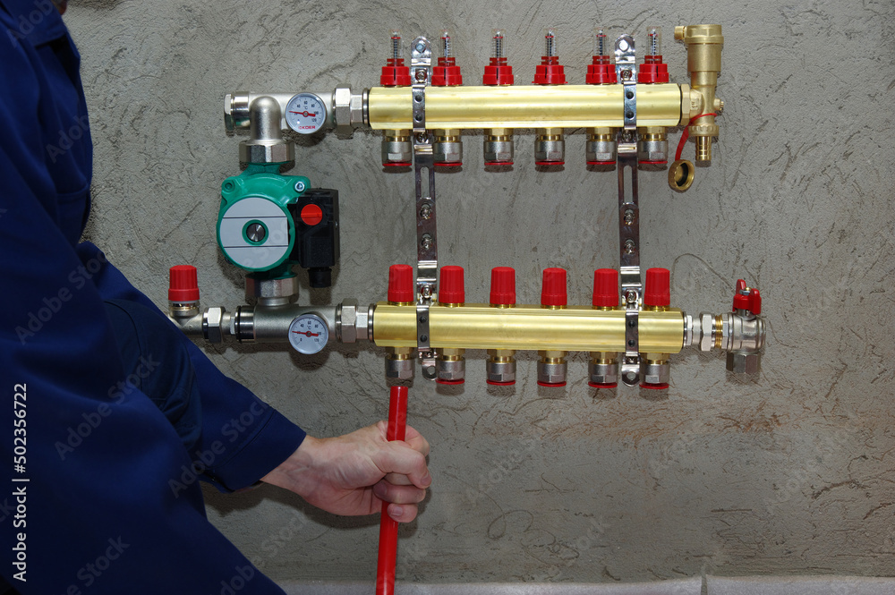 Plumber installing collector and plastic pipes Plumber installing collector and plastic pipes