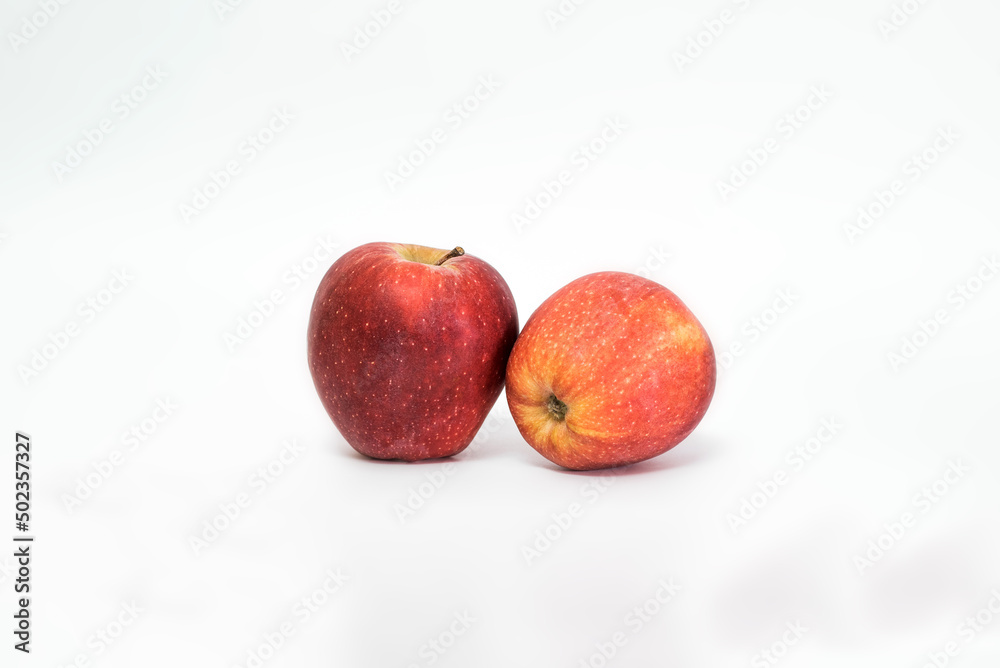 Two juicy ripe red apples isolated on white background. Healthy food. Two juicy ripe red apples isolated on white background. Healthy food.