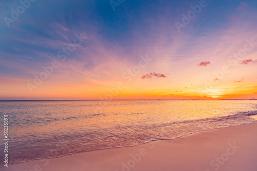 Closeup sea sand beach. Panoramic beach landscape. Inspire tropical beach seascape horizon. Orange and golden sunset sky calmness tranquil relaxing sunlight summer mood. Vacation travel holiday banner © icemanphotos