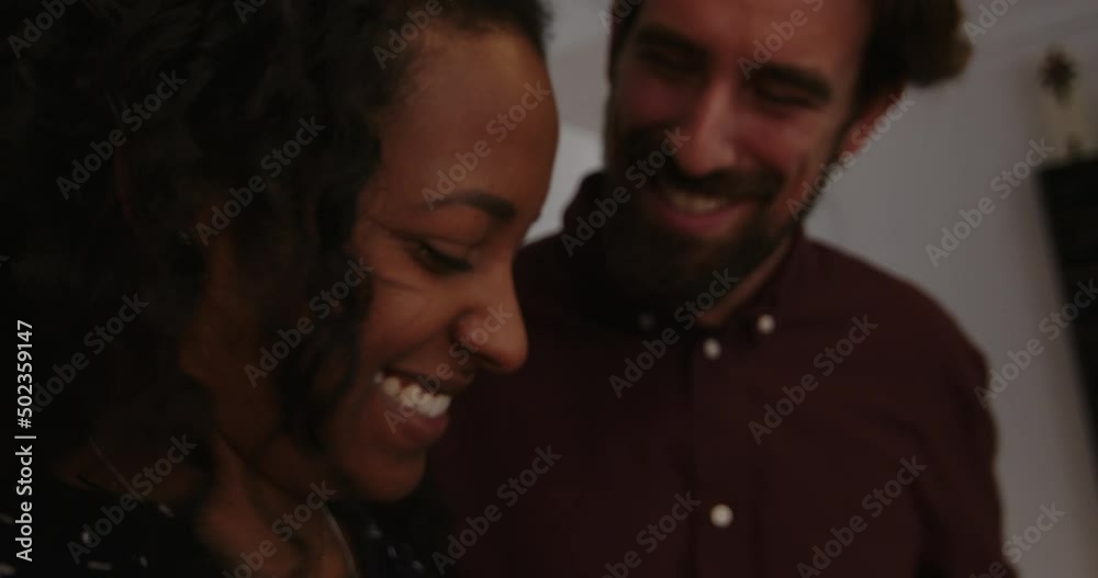 Man and woman standing in kitchen and working together while preparing meal Man and woman standing in kitchen and working together while preparing meal