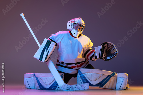 Canvas Print Portrait of teen boy, hockey player, goalkeeper catching puck with special glove