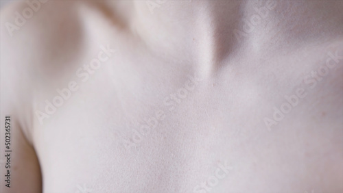 Female clavicles and neck. Action. Female clavicle. Perfect skin of a young woman close-up