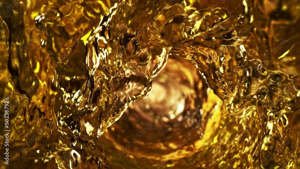 Super slow motion of pouring whiskey or ice tea drink in twister shape. Filmed on high speed cinema camera, 1000 fps.