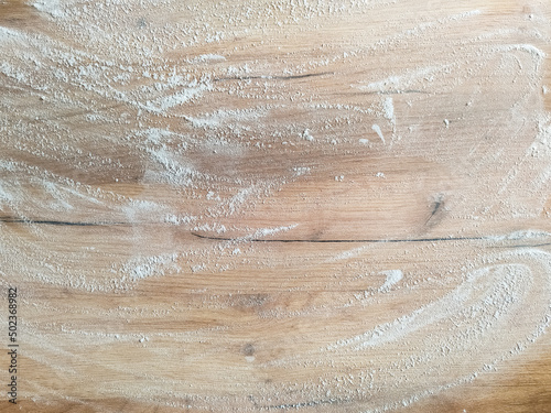 White flour on wooden table. Free space for text. View from above. Top view. 
