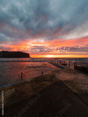 Colorful sky over Bilgola Beach rock pool at dawn  Sydney  Australia.