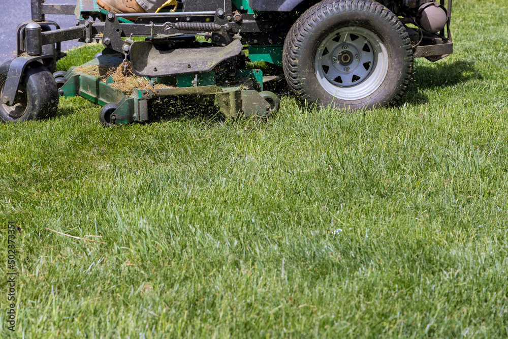 Machine for cutting lawns mover on green grass in garden with summer works Machine for cutting lawns mover on green grass in garden with summer works