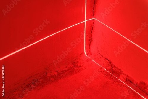Red laser beams in a room with red lighting