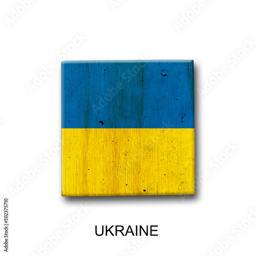 Ukraine flag on a wooden block. Isolated on white background. Signs and symbols.