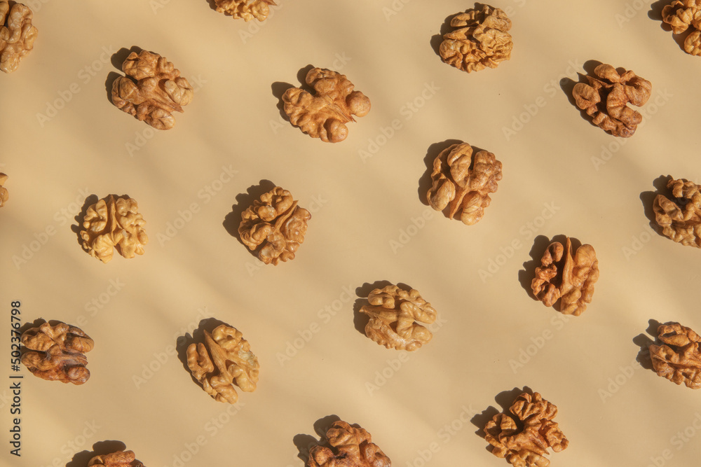Pattern with peeled halves of walnuts top view. Food abstract background with nuts Pattern with peeled halves of walnuts top view. Food abstract background with nuts