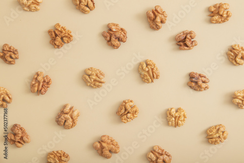 Pattern with peeled halves of walnuts top view. Food abstract background with nuts