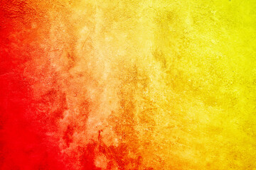 Bright abstract yellow orange red background. Toned rough surface texture. Colorful background with space for design.