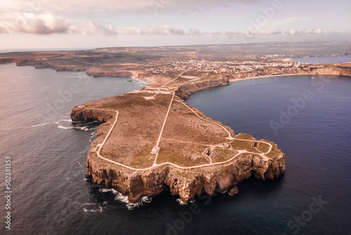 Aerial view of Sagres fortress (Fortaleza de Sagres) and the lighthouse on the cliff facing the Atlantic Ocean, Sagres, Algarve region, Portugal. photo