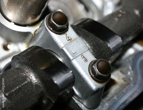 A closeup macro photo of a camshaft on a V6 car.
