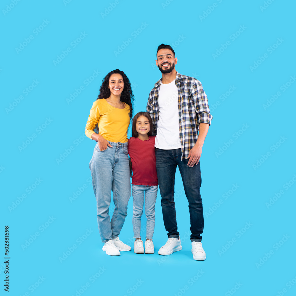 Modern Arabic Family Standing Embracing On Blue Background