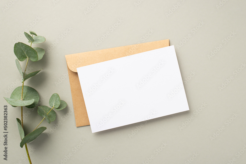 Business concept. Top view photo of paper card craft paper envelope and eucalyptus sprig on pastel grey background with blank space - obrazy, fototapety, plakaty 