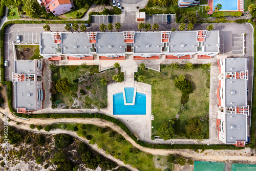 Aerial view of a luxury resort along the beach with swimming pool in backyard, Troia Peninsula, Setubal, Portugal. photo